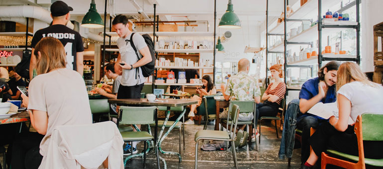 People eating in the cafeteria and chatting