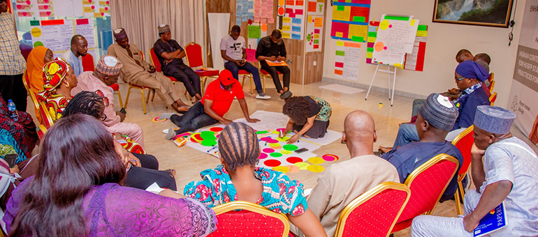 Group sitting and learning about the HCD Toolkit