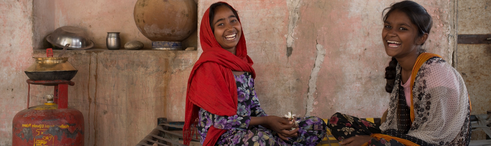 Two girls smiling throwing flowers