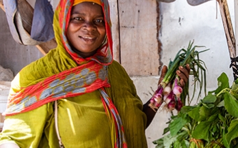 a woman selling onions in a market