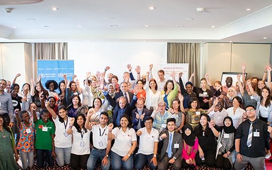 Adolescents and various people raise their hands to the sky, Geneva, May 2018
