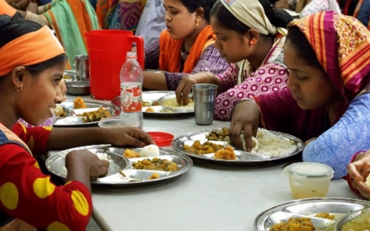 Women wearing colorful clothes eating together Bangladesh