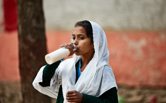 Young girl drinking milk