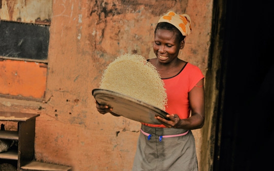 Woman mixing rice in Nigeria